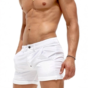 Close-up of men's slim fit white cotton shorts with button fly and rolled hem detail