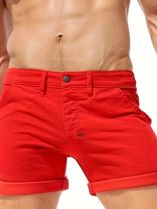 Close-up of vibrant red men's cotton casual shorts with metal button and cuffed hem