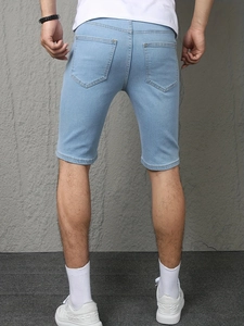 Back view of men's slim fit light blue washed denim shorts with classic large pockets