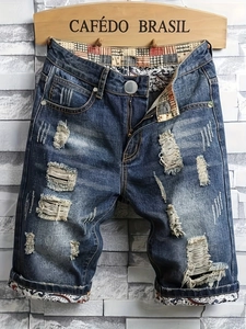 Distressed men's denim shorts with vintage wash and unique geometric pattern lining