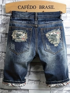 Men's dark blue denim shorts with heavy distressing and paisley patterned cuffs