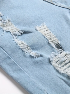 Light blue distressed denim shorts for men featuring heavy ripped details and white fibers