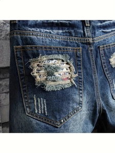 Men's distressed dark blue denim shorts featuring paisley patch pockets and washed finish