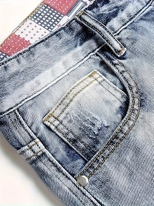 Men's light blue washed cargo denim shorts with vintage star patch and metal rivets