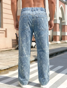 Detail of loose straight-leg men's jeans with unique white marble tie-dye acid wash pattern