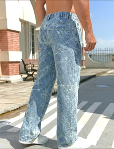 Detail of light blue marble-wash denim pants with a relaxed straight fit and retro finish