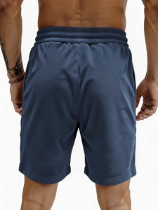 Men's navy corduroy textured athletic shorts with elastic waistband from a back view