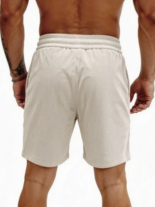 Beige men's corduroy shorts with elastic drawstring waist in a casual summer style