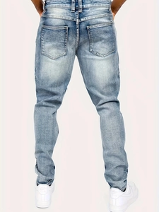 Slim fit light blue distressed men's denim jeans with washed finish from back view