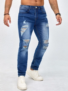 Slim fit men's ripped jeans in mid-blue with wash texture and distressed detailing