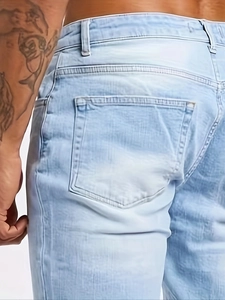 Slim fit light blue washed denim jeans featuring classic five-pocket design and rear detail