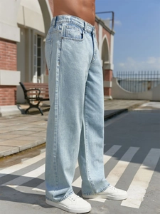 Men's loose light blue wide-leg denim jeans with high waist and adjustable drawstring
