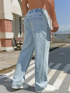 Detail view of light blue straight denim jeans with elastic drawstring waist design