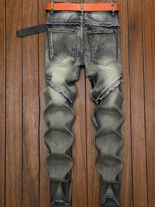 Vintage wash blue streetwear jeans with 3D wavy stacked legs and distressed raw edges