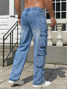 Men's loose fit light blue washed cargo jeans with elastic waist and flap pockets