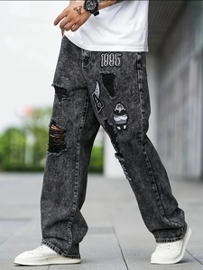 Men's street style dark gray distressed jeans with vintage patches and ripped details
