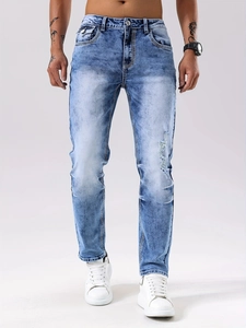 Slim fit light blue distressed jeans for men with washed cat-whisker texture and ripped details
