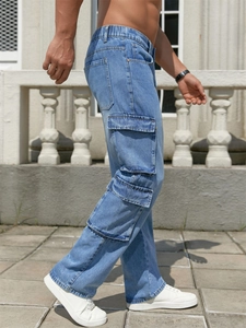 Close-up of light blue men's cargo jeans featuring side flap pockets and a relaxed fit
