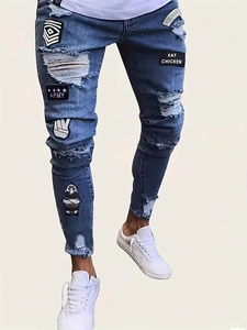 Slim fit distressed blue denim jeans with military embroidery and star patches