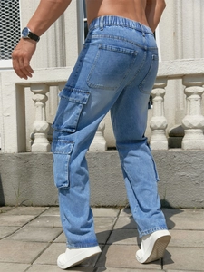 Detail of blue men's cargo jeans showing elastic waist and large utility side pockets