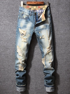 Men's slim straight distressed jeans in light blue wash with skull print waistband