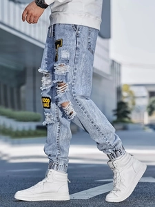 Men's light blue distressed slim fit joggers with heavy embroidery and ribbed cuffs