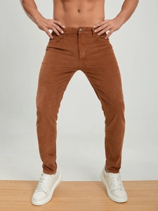 Men's brown corduroy trousers in a slim fit style with high-quality ribbed fabric texture