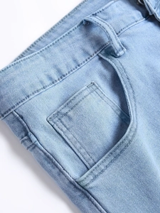 Men's slim-fit ripped blue denim jeans featuring detailed waist stitching and coin pocket