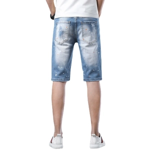 Men's light blue distressed denim shorts with paint splatter effect and rear pockets