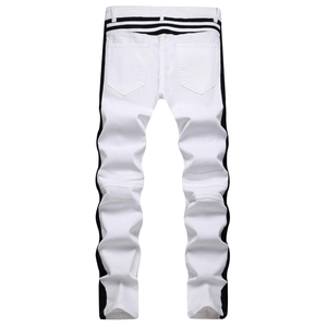 Detail of white biker jeans featuring black side stripes and accordion pleated knees
