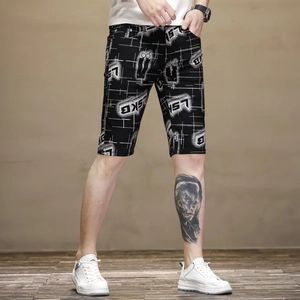 Detail view of men's slim fit black shorts with white grid pattern and LSKB print