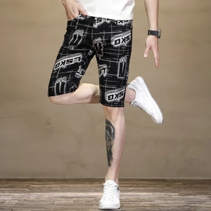 Close-up of men's slim fit summer shorts with SKB letter print and geometric pattern