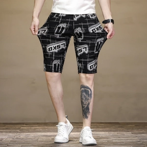 Detail view of the high-stretch fabric on men's slim fit black shorts with white logo print