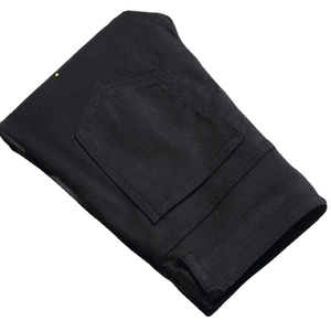 Men's slim fit black denim pants with unique paint splatter and tapered stretch design