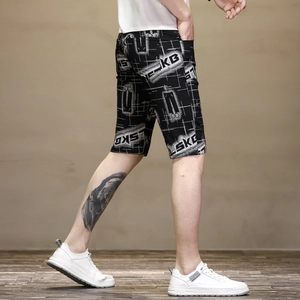 Men's slim-fit black summer shorts with white graphic lettering and geometric patterns