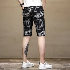 Rear view of men's slim fit black shorts with white grid patterns and LSKB print