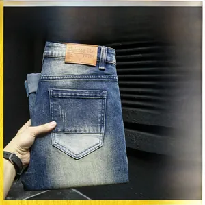 Detail of dark blue men's jeans featuring vintage whiskers and cat-scratch washing effects