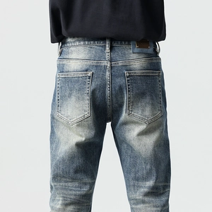 Men's retro slim fit denim jeans with patch stitching and washed faded finish back view