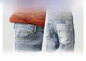 Detail of color-block patchwork pockets and embroidery on light blue washed denim jeans