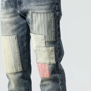 Fashionable men's slim fit straight jeans with vintage patchwork and denim fabric textures