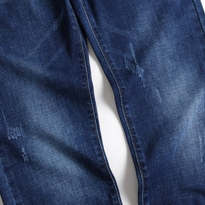 Classic washed blue men's straight jeans with vintage whiskers and denim texture detail