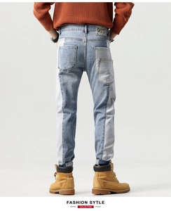 Detailed back view of patchwork denim jeans with cargo pockets and leather waist brand tag