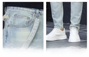 Close-up of distressed light blue denim jeans showing frayed pocket details and slim fit