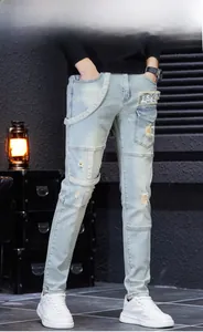 Detail of light blue slim fit jeans featuring knee distress and LSKP fabric patches