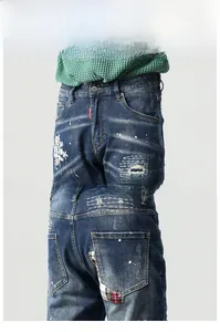 Detailansicht der Jeans mit Blumenstickerei, Farbspritzern und modischen Distressed-Patches