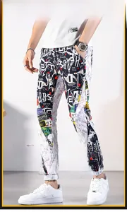 Close-up of graffiti print detail on black and white slim fit street style jogger pants