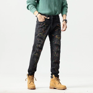 Men's retro slim fit black distressed jeans with paint splatter and ripped patchwork details
