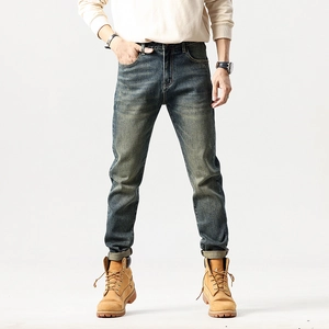 Vintage slim straight men's washed blue jeans with natural fading and whisker detailing