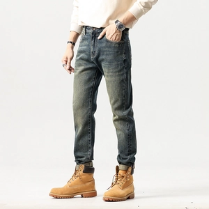 Slim fit men's vintage washed blue denim jeans with retro whiskering effects