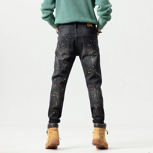Slim fit black jeans with vibrant colorful graffiti paint splatters for men
